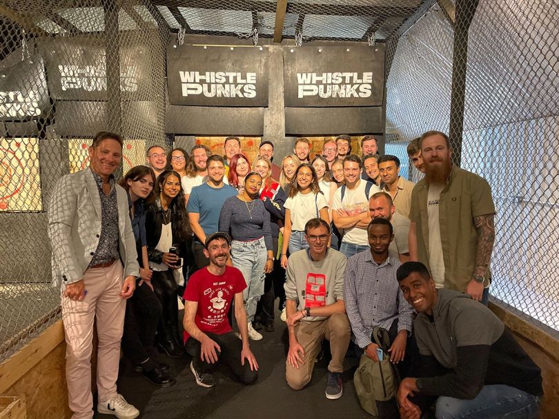 eduMe team photo at an axe throwing facility