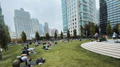 Dozens of people, including Celonis team members, enjoying yoga in the park with a cityscape background. Dozens of people, including Celonis team members, enjoying yoga in the park with a cityscape background.