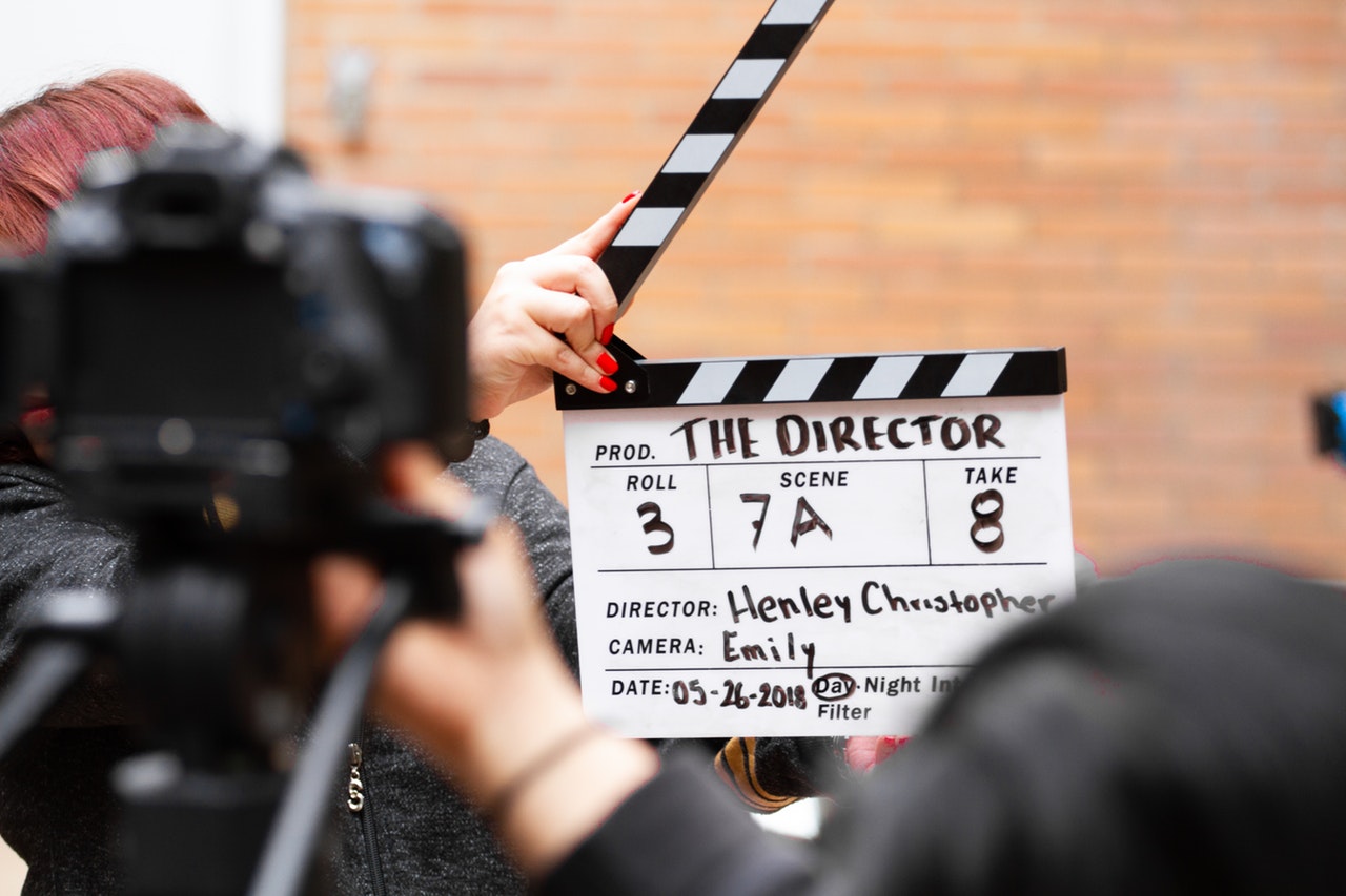 a person holding a clapper board